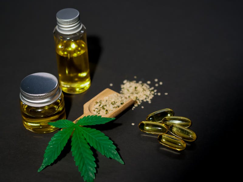 CBD oil, capsules, and cannabis leaf — holistic wellness products